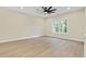 Bright bedroom with large window, ceiling fan, and wood-look flooring at 447 Teague Nw Dr, Kennesaw, GA 30152