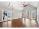 Bright living room boasts hardwood floors, vaulted ceilings and a wall of windows at 5030 Berkshire Ct, Suwanee, GA 30024