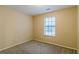 Bright bedroom featuring a large window and carpet flooring at 1841 Northwick Pl, Lithonia, GA 30058