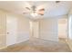 Main bedroom with ceiling fan, carpet, and access to bathroom at 1841 Northwick Pl, Lithonia, GA 30058