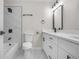 Modern bathroom with white vanity, marble-look tile, and updated fixtures at 3056 Hidden Forest Dr, Snellville, GA 30078