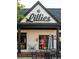 Lillies storefront features a charming white exterior, black accents, and outdoor seating at 3157 Moor View Rd # 34, Duluth, GA 30096