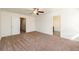 Spacious bedroom with carpet, ceiling fan and access to hallway at 4940 Elm Brook Dr, Atlanta, GA 30349