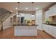 Modern kitchen with white cabinets, dark granite countertops, and a center island at 5104 Davenport Pl, Roswell, GA 30075