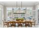 Sunlit dining room with a rustic wooden table and a view to the backyard at 6191 Talmadge Run, Acworth, GA 30101