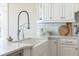 Modern kitchen features a farmhouse sink and a sleek gooseneck faucet at 6191 Talmadge Run, Acworth, GA 30101