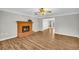 Living room with a brick fireplace and hardwood floors, leading to another room at 2701 Treehouse Ln, Lawrenceville, GA 30044