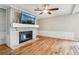 Bright living room with hardwood floors, fireplace, and ceiling fan at 1540 Woodcreek Dr, Cumming, GA 30041