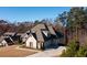 Aerial view showcasing the roof and rear exterior with a three-car garage at 1560 Tapestry Rdg, Lawrenceville, GA 30045