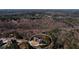 Wider aerial perspective of the home's location in a wooded area, circled at 1560 Tapestry Rdg, Lawrenceville, GA 30045