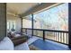 Covered back deck with seating, overlooking wooded area at 1560 Tapestry Rdg, Lawrenceville, GA 30045