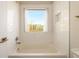 Modern bathroom with white subway tile, a bathtub, and natural light at 1560 Tapestry Rdg, Lawrenceville, GA 30045
