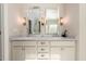 Modern bathroom with dual vanities, marble countertops, and ample lighting at 1560 Tapestry Rdg, Lawrenceville, GA 30045