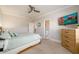 Bright bedroom featuring carpeted floors, ceiling fan, and a view into the bathroom at 1560 Tapestry Rdg, Lawrenceville, GA 30045
