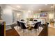 Open-concept dining area adjacent to the living room, featuring a marble-topped table and velvet chairs at 1560 Tapestry Rdg, Lawrenceville, GA 30045