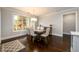 Dining room with large window, wood floors, and a table with seating for six at 1560 Tapestry Rdg, Lawrenceville, GA 30045