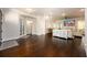Open-concept dining area with hardwood flooring, showcasing the entryway, and a glimpse of the living room at 1560 Tapestry Rdg, Lawrenceville, GA 30045