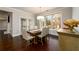 Elegant dining area with a large window, wood floors, and a stylish dining table at 1560 Tapestry Rdg, Lawrenceville, GA 30045