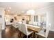 Dining area with hardwood floors, a wooden table, and access to the kitchen and living spaces at 1560 Tapestry Rdg, Lawrenceville, GA 30045