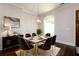 Elegant dining room with dark wood floors, a stylish chandelier, and a modern table with velvet chairs at 1560 Tapestry Rdg, Lawrenceville, GA 30045