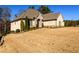 Side view of a brick home with a landscaped yard at 1560 Tapestry Rdg, Lawrenceville, GA 30045