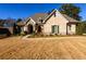 Beautiful brick home with arched entryway and manicured landscaping at 1560 Tapestry Rdg, Lawrenceville, GA 30045
