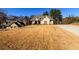 Front view of a brick home with a driveway and dry lawn at 1560 Tapestry Rdg, Lawrenceville, GA 30045