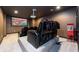 Home theater with tiered seating, projector, and popcorn machine at 1560 Tapestry Rdg, Lawrenceville, GA 30045