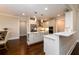 White kitchen with island, stainless steel appliances, hardwood floors, and breakfast bar at 1560 Tapestry Rdg, Lawrenceville, GA 30045