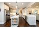 Bright white kitchen with a large island, stainless steel appliances, and hardwood floors at 1560 Tapestry Rdg, Lawrenceville, GA 30045