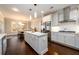Bright, spacious kitchen featuring white cabinetry, an island with marble countertop, and stainless steel appliances at 1560 Tapestry Rdg, Lawrenceville, GA 30045