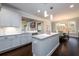 Modern kitchen with white cabinets, a large island, stainless steel appliances, and an adjacent dining area at 1560 Tapestry Rdg, Lawrenceville, GA 30045