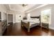 Spacious main bedroom with hardwood floors, a cozy bed, and access to a private bathroom at 1560 Tapestry Rdg, Lawrenceville, GA 30045