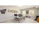 Home office in the basement with a table, computer, and framed photos at 1560 Tapestry Rdg, Lawrenceville, GA 30045