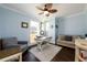 Home office with light blue walls, wood floors, a ceiling fan, and comfortable seating at 1560 Tapestry Rdg, Lawrenceville, GA 30045