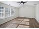 Living room with wood-look floors, white walls, and multiple large windows at 2289 Baker Station Dr, Acworth, GA 30101