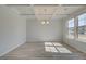 Spacious dining room with light gray walls, chandelier, and wood-look floors at 2296 Cadenza Cir, Dacula, GA 30019