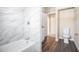 Bathroom with marble-look tile and new fixtures at 2496 Montezuma Cir, Ellenwood, GA 30294
