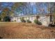 Ranch style home with a spacious lawn and mature trees at 2496 Montezuma Cir, Ellenwood, GA 30294