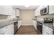 Renovated kitchen with granite counters and stainless steel appliances at 2496 Montezuma Cir, Ellenwood, GA 30294