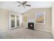 Living room with fireplace, French doors, and ceiling fan at 2496 Montezuma Cir, Ellenwood, GA 30294