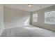 Spacious bedroom featuring two windows and carpet at 238 Arnewood Cir, Mcdonough, GA 30253