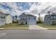 Two-story light blue house with a white garage door and brick accents at 238 Arnewood Cir, Mcdonough, GA 30253