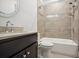Clean bathroom with a shower/tub combo, dark vanity, and tile surround at 333 Brownstones Ne Cir, Atlanta, GA 30312