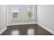 Well-lit bedroom with hardwood floors and two windows at 333 Brownstones Ne Cir, Atlanta, GA 30312