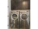 Bright laundry room with modern LG washer and dryer, and dark brown cabinets at 333 Brownstones Ne Cir, Atlanta, GA 30312