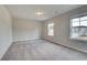 Spacious bedroom with carpet flooring and multiple windows at 412 Brekston Way, Mcdonough, GA 30253