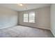 Bright bedroom with neutral carpeting and two windows at 412 Brekston Way, Mcdonough, GA 30253