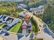 Aerial view of a red two-story house in a residential area with trees at 100 Academy Ln, Canton, GA 30114