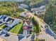 Aerial view of a red two-story house in a neighborhood with green lawns and trees at 100 Academy Ln, Canton, GA 30114